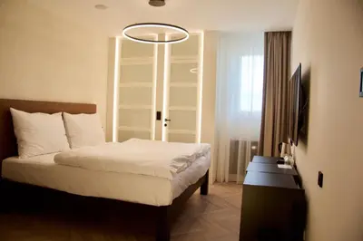 a bedroom with a bed and a flat screen tv at Chevron Hotel in Prague