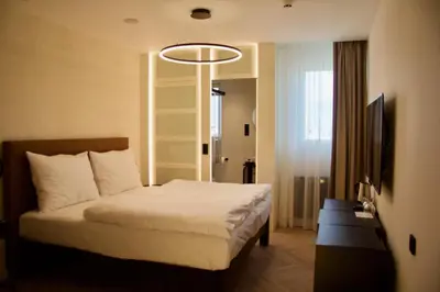 a hotel room with a bed and a television at Chevron Hotel in Prague