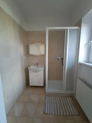 a small bathroom with a shower and a sink at Vila Malvazinky in Prague