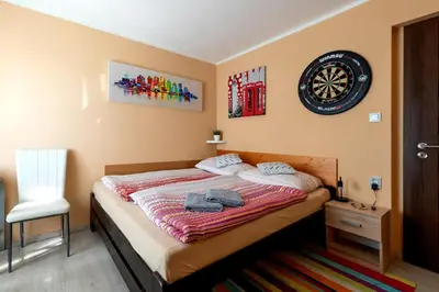 a bedroom with a bed and a clock on the wall at Cozy room at metro station, private bathroom, 9minutes oldtown, 15minutes airport, WiFi in Prague