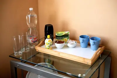 a glass table with blue cups on top of it at Cozy room at metro station, private bathroom, 9minutes oldtown, 15minutes airport, WiFi in Prague