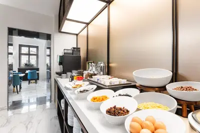 a buffet with bowls of food on a counter at Áurea Legends by Eurostars Hotel Company in Prague