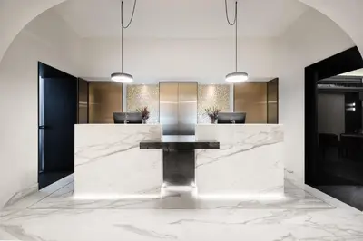 a lobby with a marble reception desk with chairs at Áurea Legends by Eurostars Hotel Company in Prague