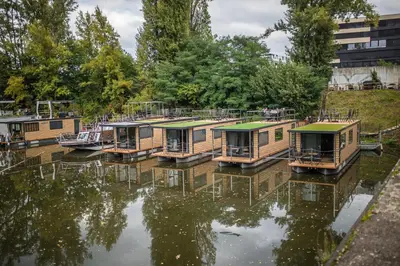 a group of houses on the water in a canal at Prague Bay Houseboats in Prague