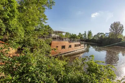 a boat is docked on a river at Prague Bay Houseboats in Prague