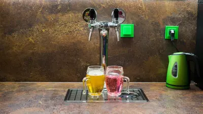 two glasses of beer sitting on a rack next to a faucet at Apartment COLOURS - your 7 colour experience in centre of Prague in Prague