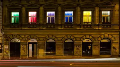 a building with colorful windows on a street at Apartment COLOURS - your 7 colour experience in centre of Prague in Prague