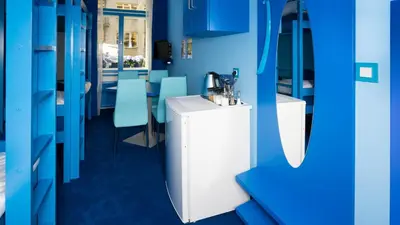 a bathroom with a sink and blue walls at Apartment COLOURS - your 7 colour experience in centre of Prague in Prague