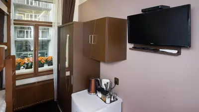 a room with a flat screen tv on a wall at Apartment COLOURS - your 7 colour experience in centre of Prague in Prague