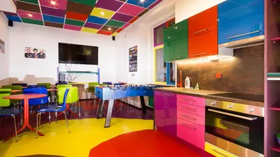 a kitchen with colorful cabinets and a table and chairs at Apartment COLOURS - your 7 colour experience in centre of Prague in Prague