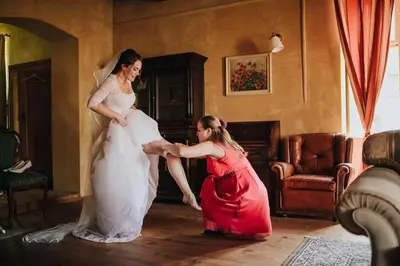 a woman is helping a girl in a wedding dress at Apartmány č.p. 9 in Kouřim