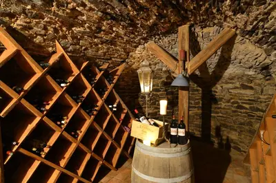 a room with a bunch of wine bottles in a barrel at Apartmány č.p. 9 in Kouřim