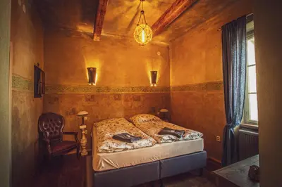 a bedroom with a bed and a chair in it at Apartmány č.p. 9 in Kouřim