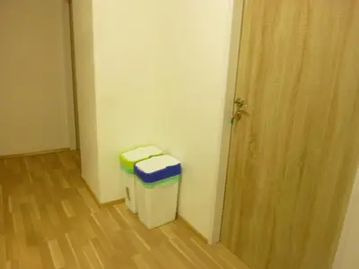a room with a trash can next to a door at Apartmán VAN NG in Prague