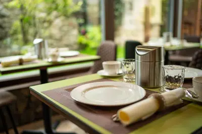 a table with a white plate on top of it at Hotel Anna in Beroun