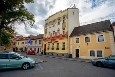a city street with cars parked in front of a building at Hotel Anna in Beroun