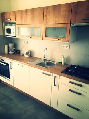 a kitchen with white cabinets and a sink at Apartment Anna Vysehrad in Prague