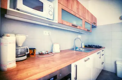 a kitchen counter with a sink and a microwave at Apartment Anna Vysehrad in Prague