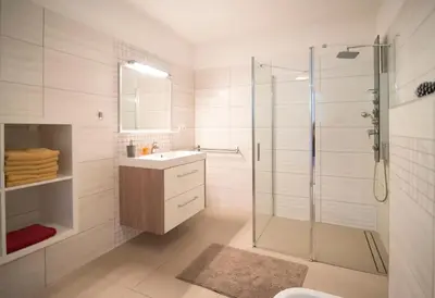 a bathroom with a glass shower and a sink at Wellness bungalov - vodní nádrž Slapy - 40km od Prahy in Nečín