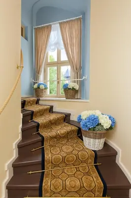 a row of stairs with blue walls and a window at Cathedral Prague Apartments in Prague