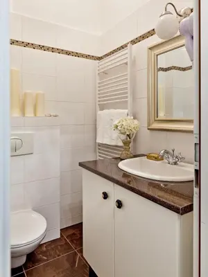 a bathroom with a sink and a toilet at Cathedral Prague Apartments in Prague
