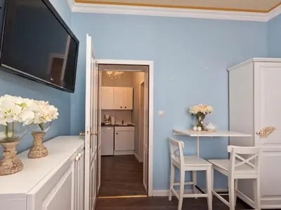 a dining room with blue walls and a table and chairs at Cathedral Prague Apartments in Prague