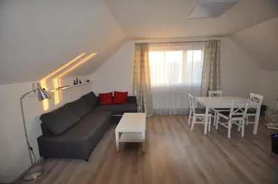 a living room with a couch and a table at Prague Gardens Appartments in Prague