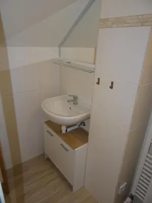 a white bathroom with a sink and a mirror at Prague Gardens Appartments in Prague