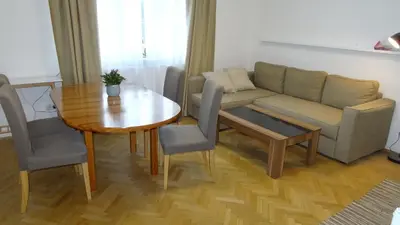 a living room with a couch and a table at Prague Gardens Appartments in Prague