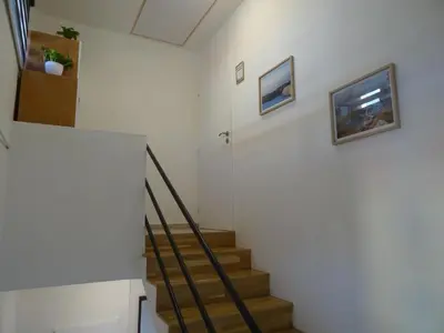 a staircase in a home with white walls and wooden floors at Prague Gardens Appartments in Prague