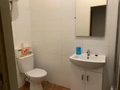 a bathroom with a toilet and a sink at KK Apartments in Prague