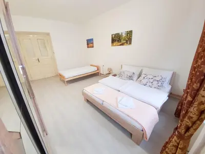 a small room with a bed and a window at KK Apartments in Prague
