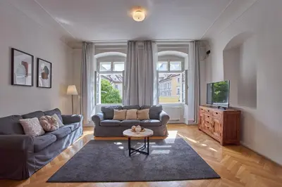 a living room with a couch and a tv at Charles Bridge Apartments in Prague