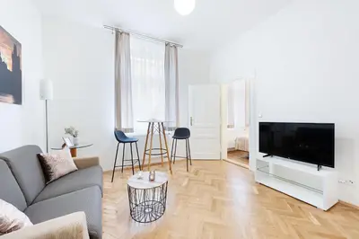 a living room with a couch and a flat screen tv at Prague Roof Apartments in Prague