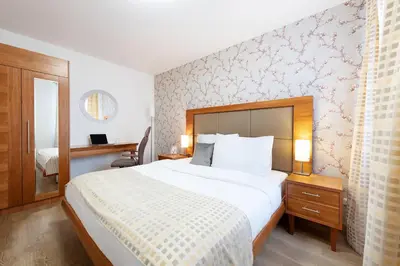a hotel room with a large bed and a mirror at Prague Roof Apartments in Prague
