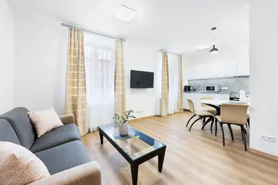 a living room with a couch and a table at Prague Roof Apartments in Prague