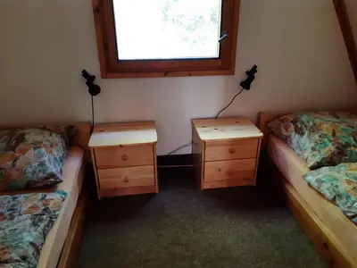 two beds and two night stands in a room at Holiday home Zajícovi in Rabyně