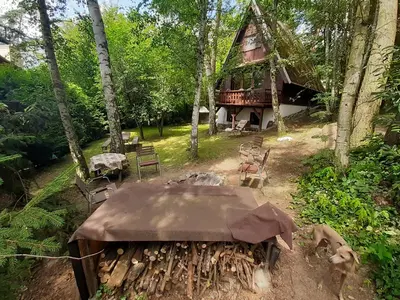 a table and chairs in front of a cabin at Holiday home Zajícovi in Rabyně