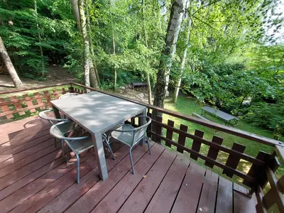 a wooden deck with a table and two chairs at Holiday home Zajícovi in Rabyně