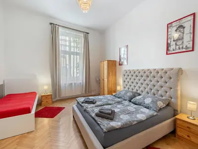a bedroom with a bed and a large window at Old Town Home Prague in Prague