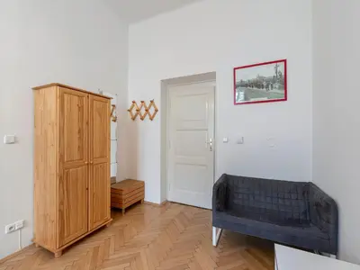 a living room with a blue couch and a cabinet at Old Town Home Prague in Prague