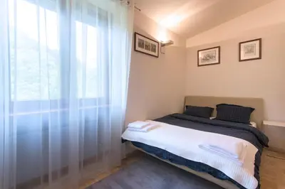 a bedroom with a bed and a window at Huge luxury central Prague VILLA, 6 beds and baths, terraces, double garage in Prague