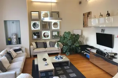 a living room with a couch and a tv at Huge luxury central Prague VILLA, 6 beds and baths, terraces, double garage in Prague