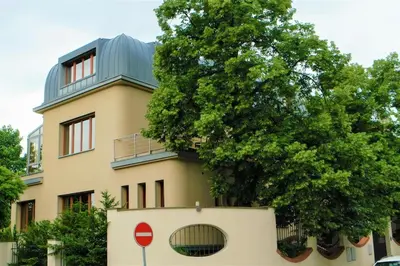 a building with a tree on top of it at Huge luxury central Prague VILLA, 6 beds and baths, terraces, double garage in Prague