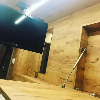 a flat screen tv on a stand in a room at Capsule Hostel Top Wenceslas square in Prague