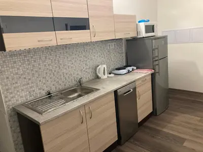 a kitchen with a sink and a refrigerator at Capsule Hostel Top Wenceslas square in Prague