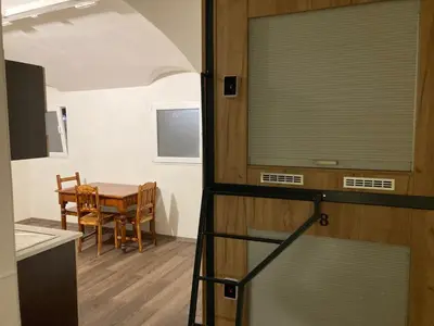 a kitchen and dining room with a table and a window at Capsule Hostel Top Wenceslas square in Prague