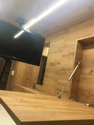 a flat screen tv sitting on top of a table at Capsule Hostel Top Wenceslas square in Prague