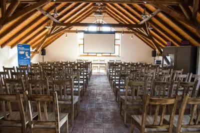 a room with rows of chairs and a projection screen at Dvůr Perlová voda in Budyně nad Ohří
