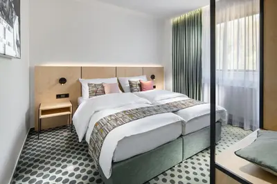 a bedroom with a large bed in a room at B&B Chuchle Arena Praha in Prague